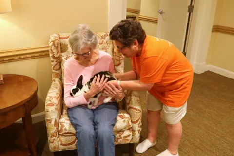 Michelle Videlock interacts with a resident 