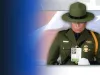 A Border Patrol agent holds the Silent Partner card of a fallen agent.