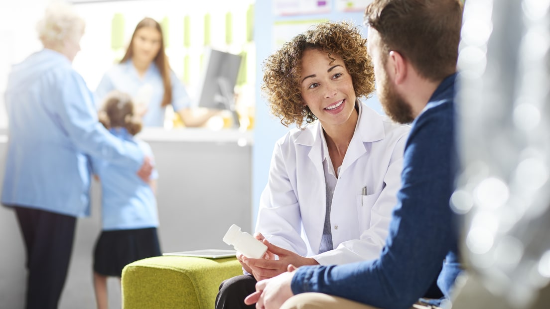 Doctor speaking with adult patient