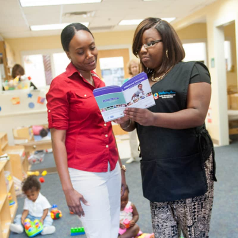 Two women standing in daycare