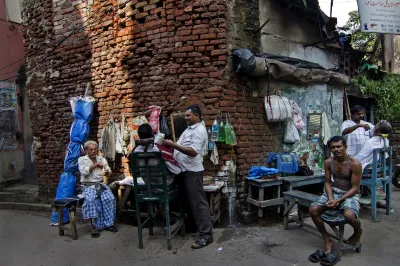 Men visit a hair salon on the street in India