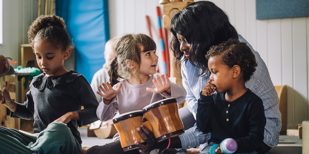 young children play with musical instruments in class