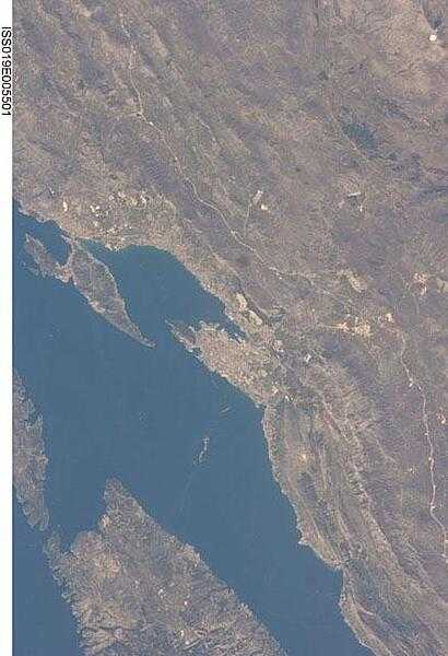 This view features the Dalmatian coastline of Croatia around the city of Split. Much of the region is characterized by the northwest-southeast-oriented islands and bays of the Adriatic Sea. This distinctive coastal geomorphology is the result of faulting caused by tectonic activity in the region. Photo courtesy of NASA.