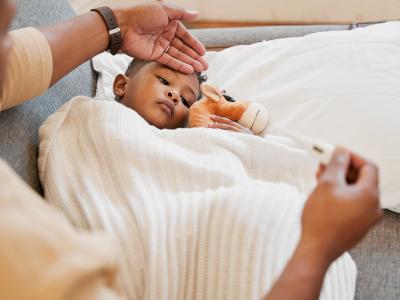 Sick child with thermometer