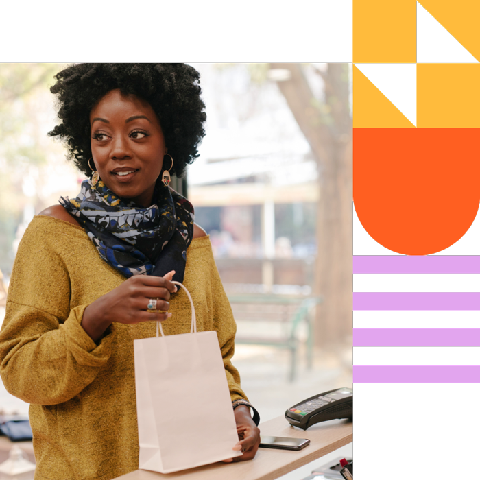 Woman holding a shopping bag at a store counter