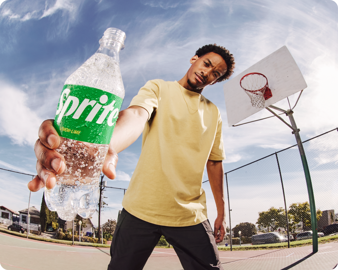 obey days - person holding sprite on basketball court