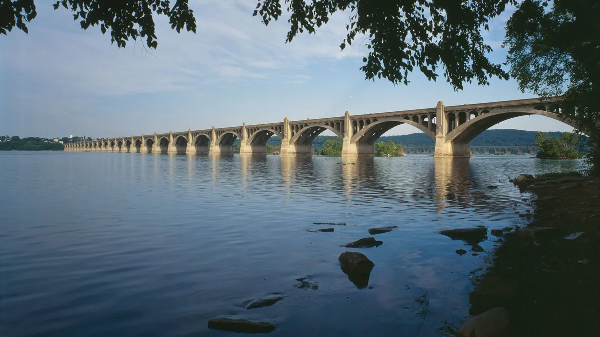 A flat bridge crosses a body of water.