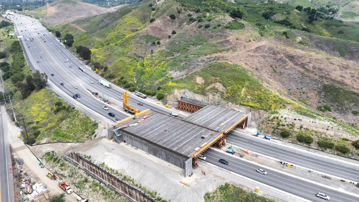 The 165-foot wide crossing, scheduled to be completed in 2026, will blend into the surroundings and allow wildlife to roam above the busy freeway where up to 300,000 vehicles pass daily.