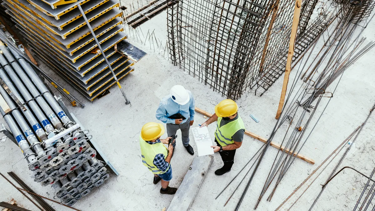 Candid shot of engineers and contractors on construction site