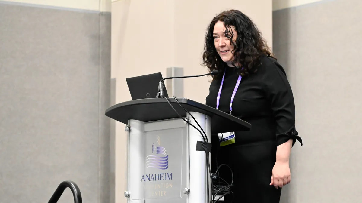 A woman at a podium.