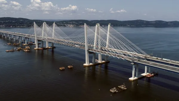 Overhead view of the silver Mario Cuomo Bridge over deep blue water.