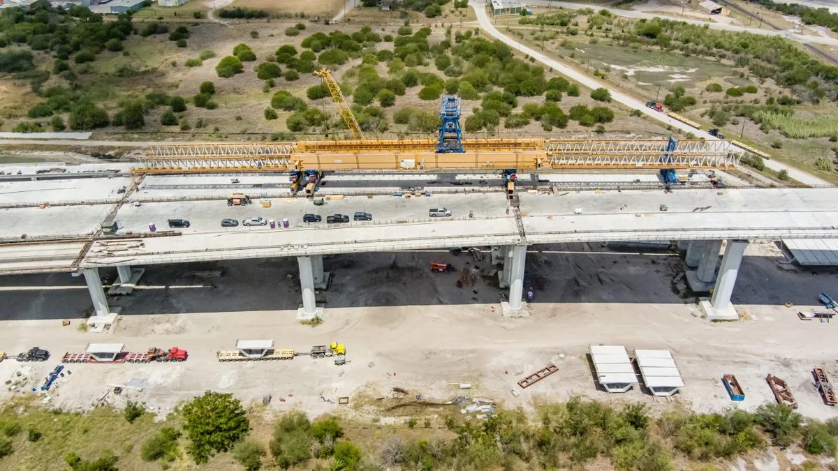 A view from above of the yellow gantry building the new bridge.