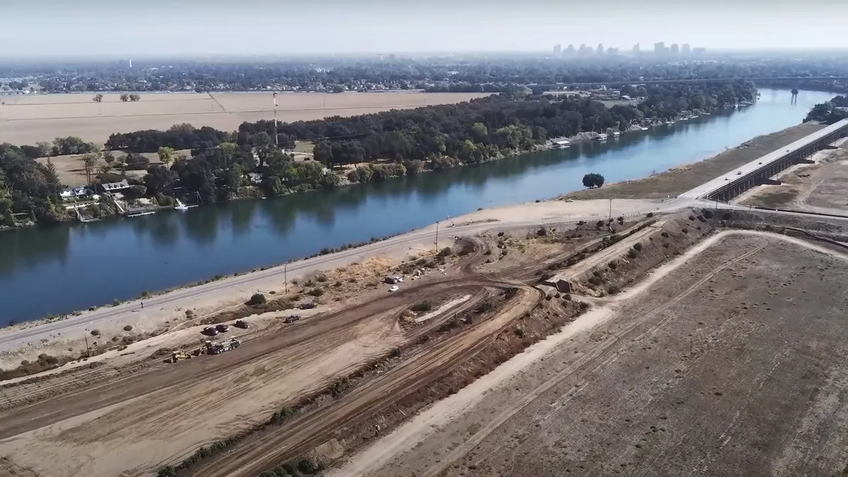 An aerial view shows preparations for the extension of a weir to mitigate flooding along the Sacramento River.