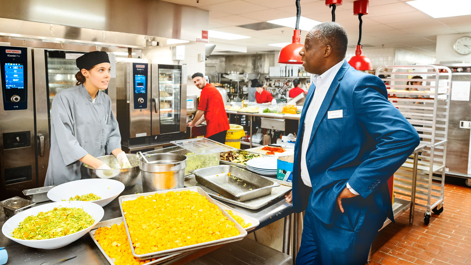 Arthur Keith ’84, general manager of the Statler Hotel, checking in with the kitchen staff.