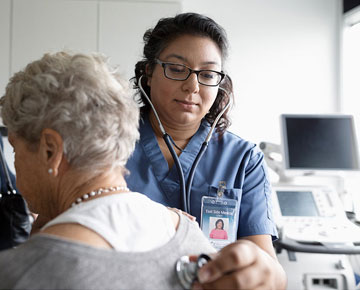 Nurse taking a patient's heart rate