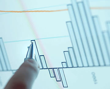 Pen pointing at a graph chart.