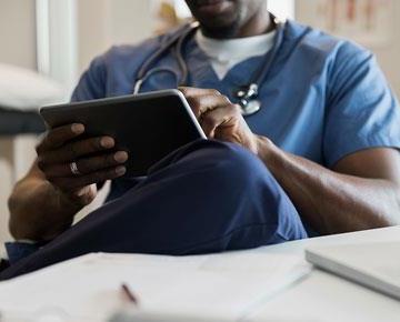 Physician on tablet device