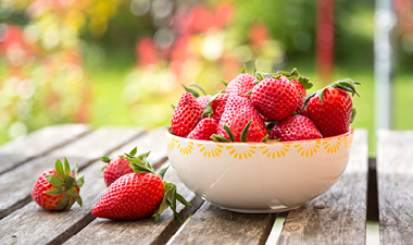 Bowl of strawberries sitting on a table