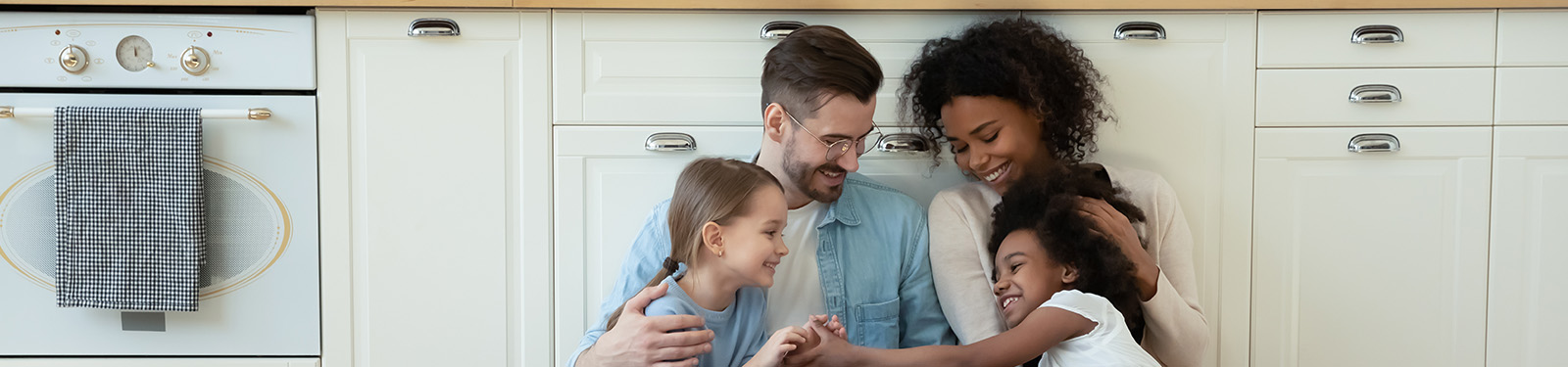 Family sitting on the floor in the kitchen