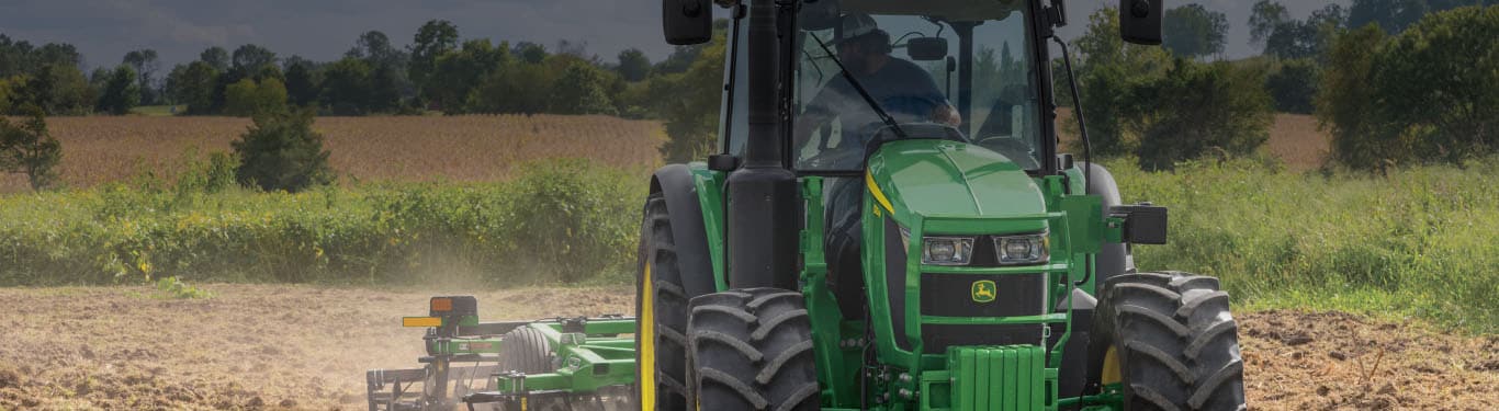 5 Series Tractor in use, pulling attachment in field