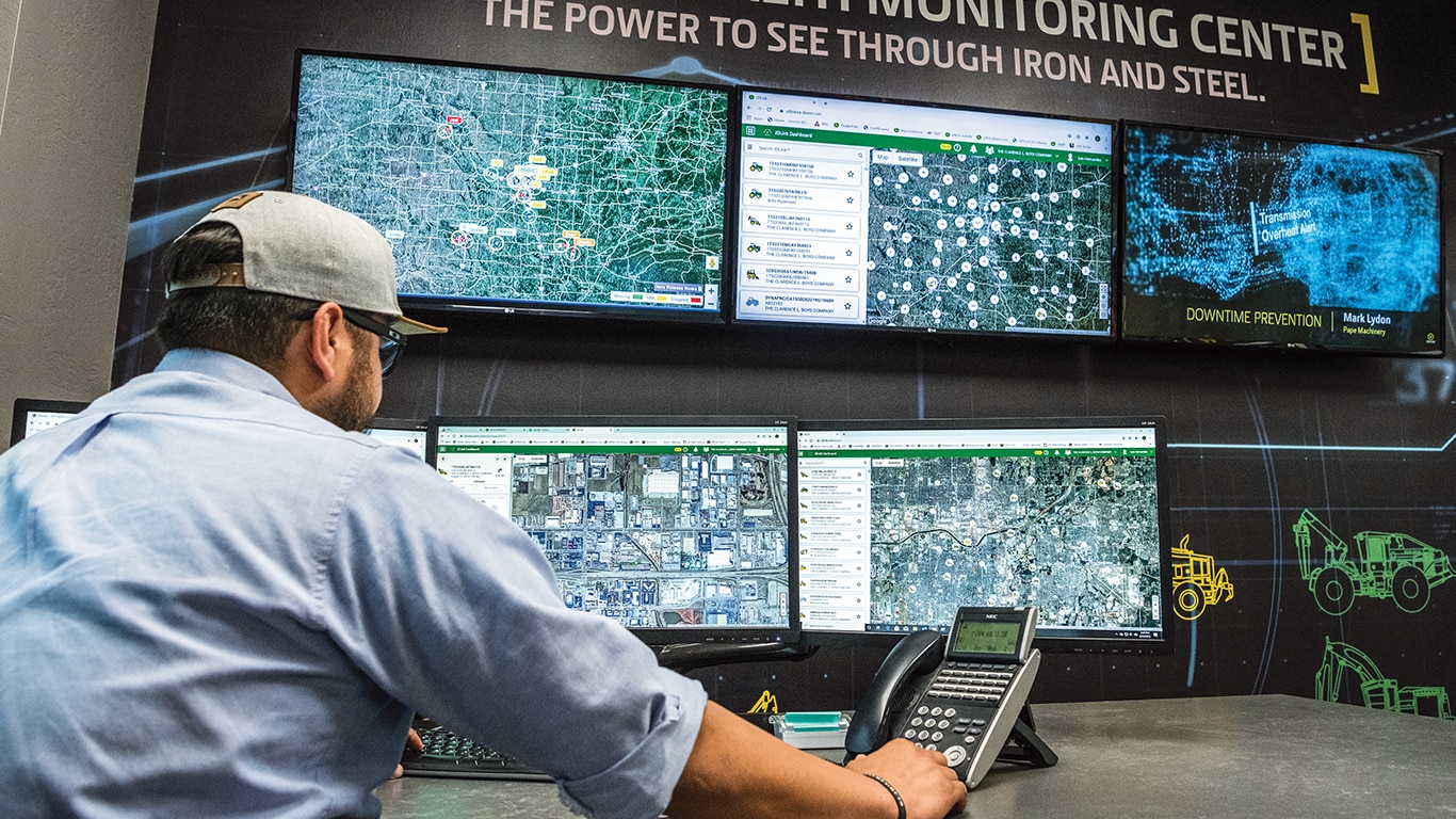 man viewing multiple computer screens with data