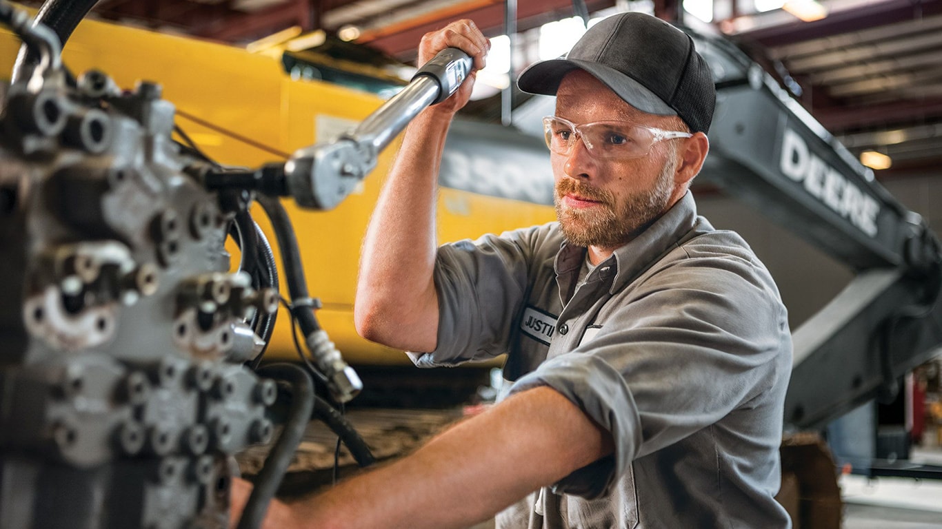 A service technician reconditioning an engine.