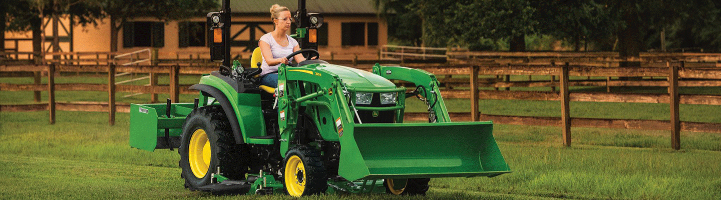 Woman riding in a properly ballasted tractor.