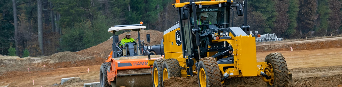 motor grader works on road