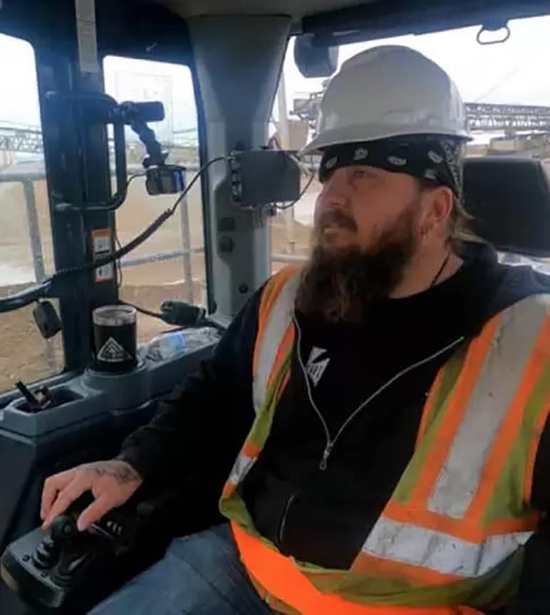 Bob inside the cab of construction equipment