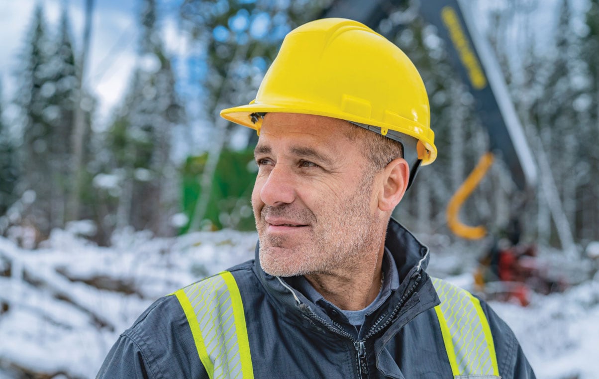 man in hard hat smiling as he looks to the left.