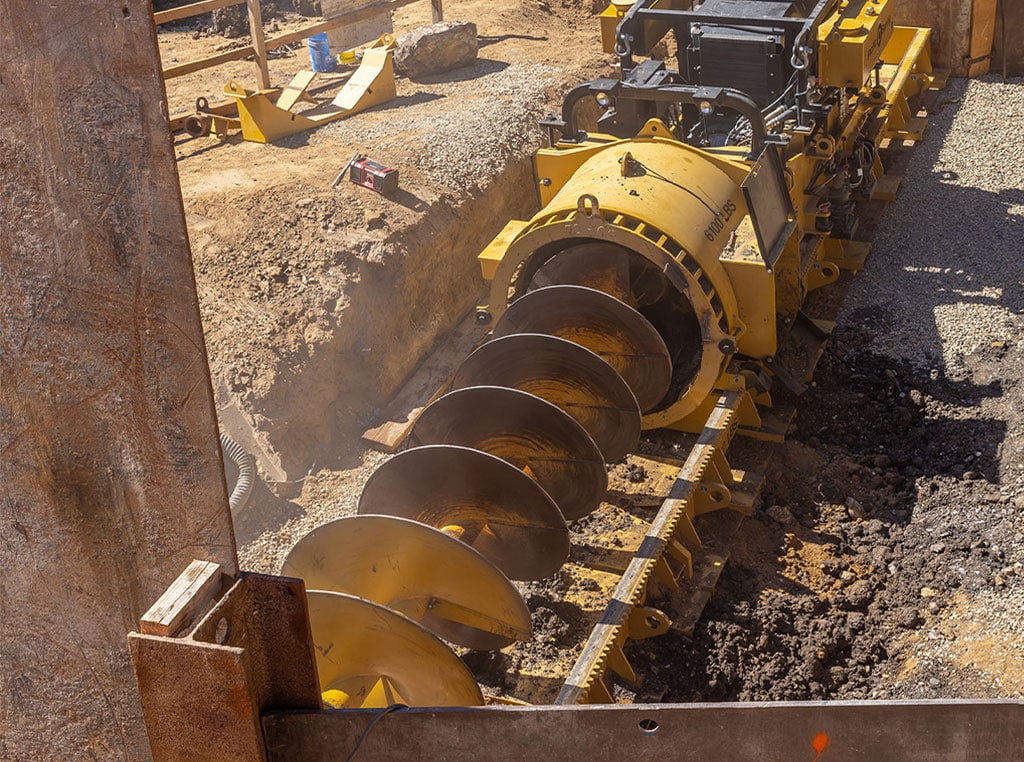 An MBM auger boring machine at work in a trenchless construction jobsite