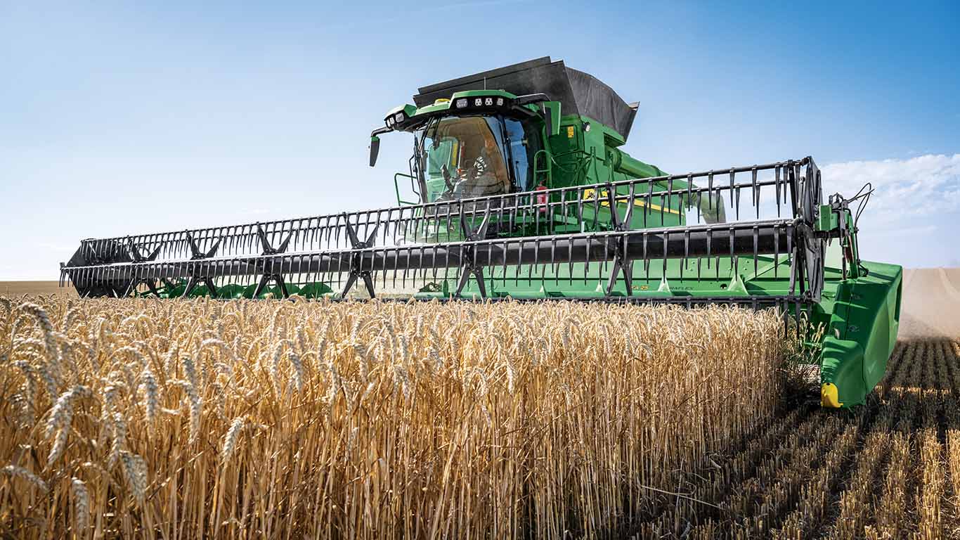 John Deere Combine with a auger platform harvesting in small grains