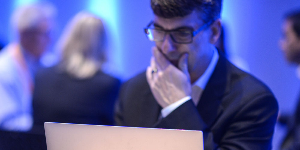 a man looks at his Dell laptop