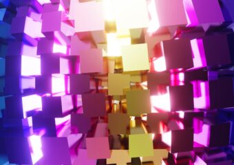 3D rendering of geometric shapes of pink, purple, blue and gold colors backlit.