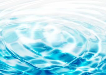 Water rippling in concentric circles against a turquoise blue background.