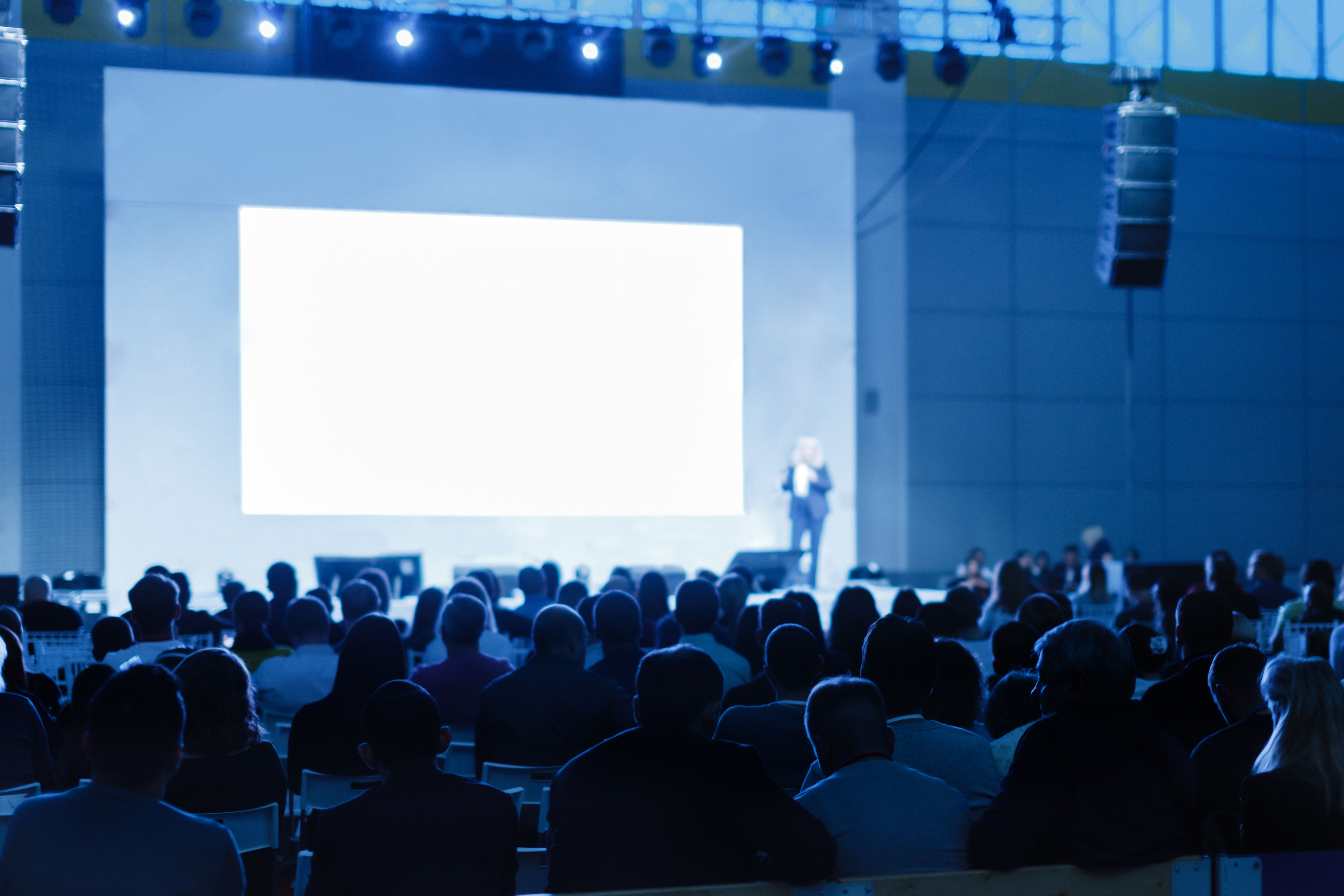 Speaker on stage giving a talk to an audience