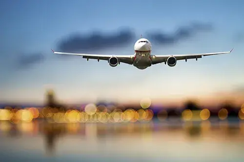 Image of an airplane taking off over a runway