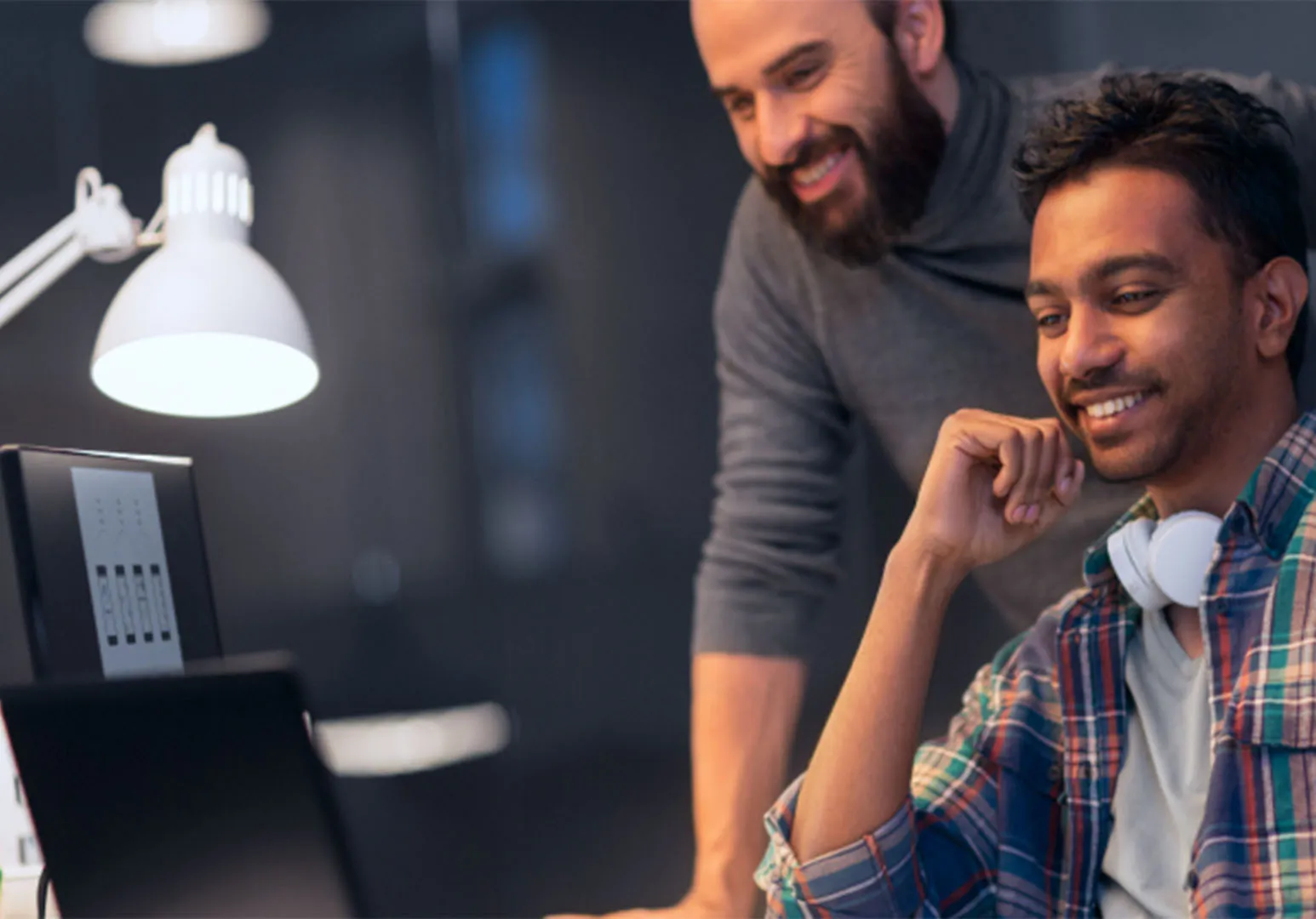 Two people looking at desktop