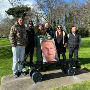 Family, friends and pro skater Chewy Cannon, with a photo of Ollie Nicholls, at the unveiling of the skateboard memorial bench in Normanston Park, Lowestoft earlier this year. Picture: The Nicholls family