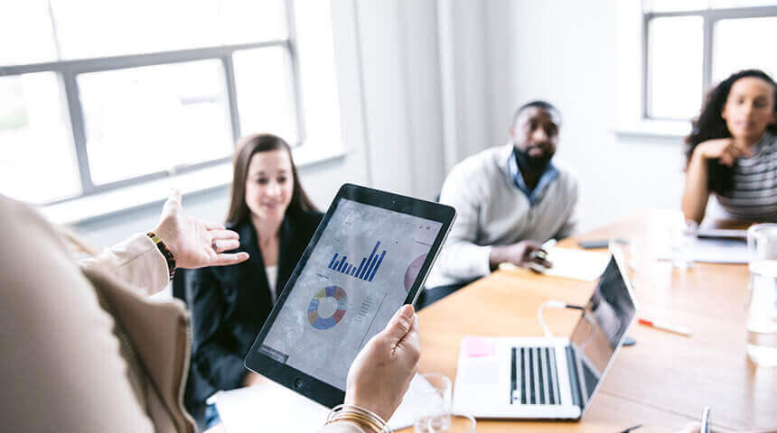 Businesswoman explaining data from tablet