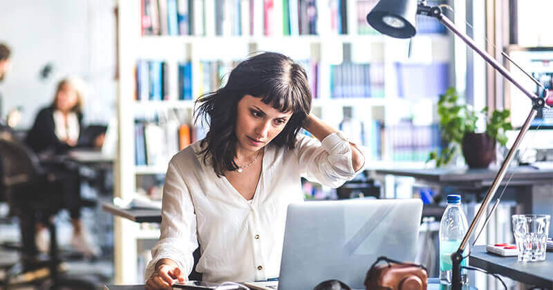 Businesswoman looking at laptop