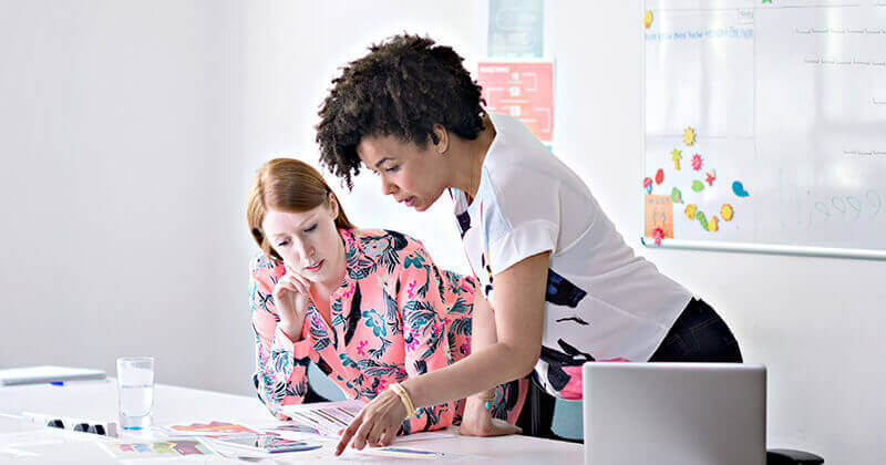 two businesswomen discussing process