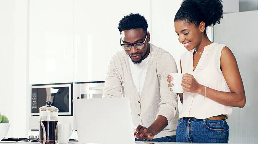 Couple looking at laptop at home