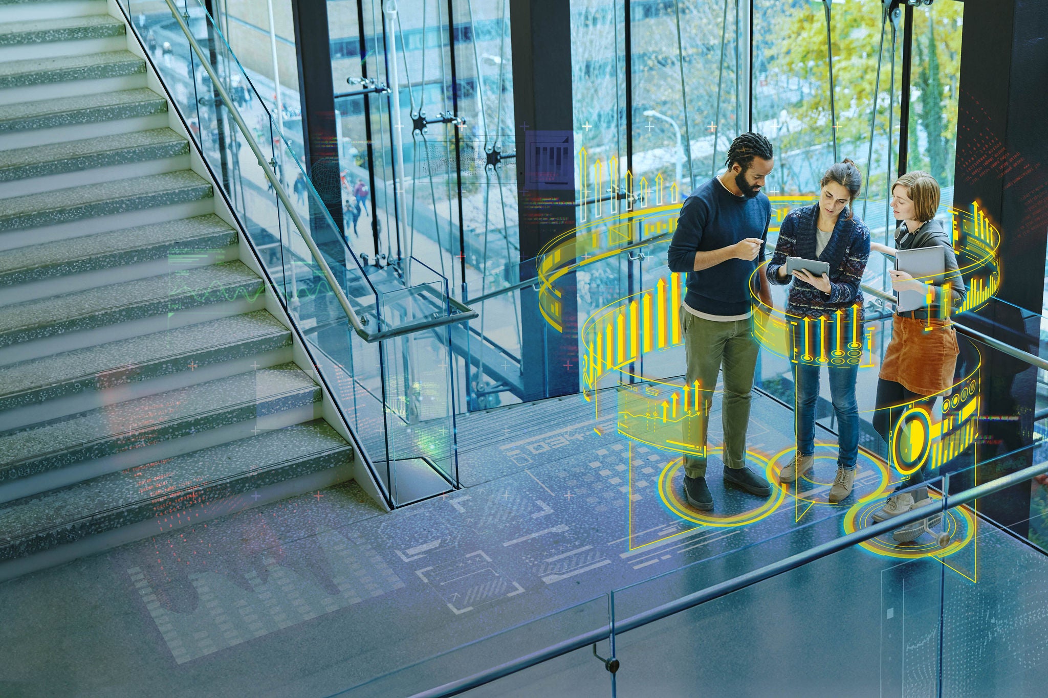 Coworkers discussing project on digital tablet on stairs of office building