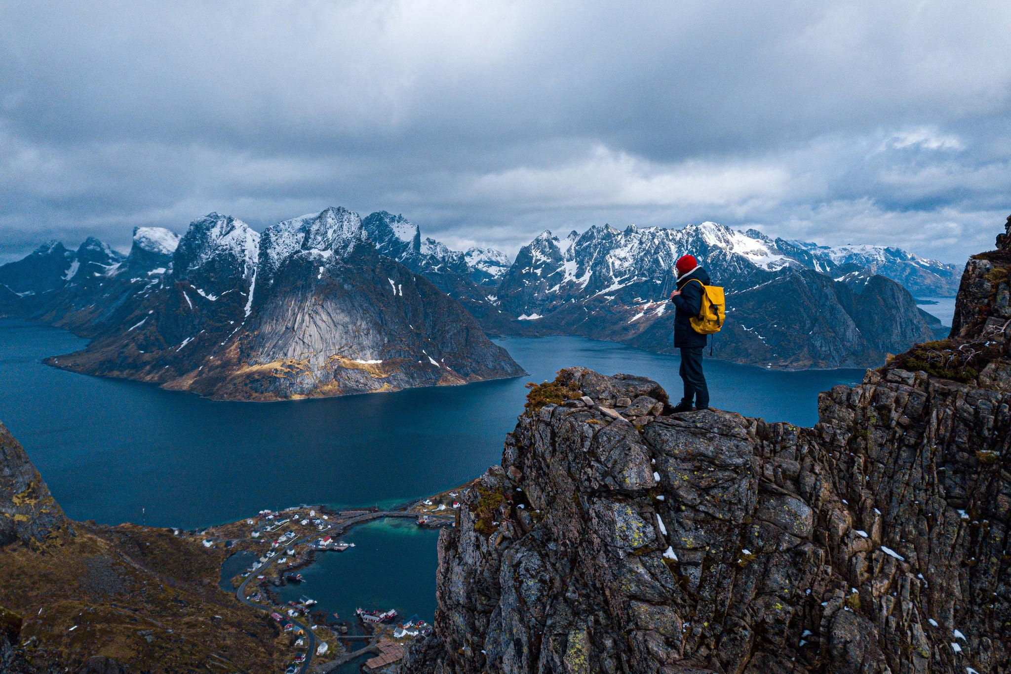 travel and adventure background, hiker with backpack enjoying sunset landscape in Lofoten, Norway