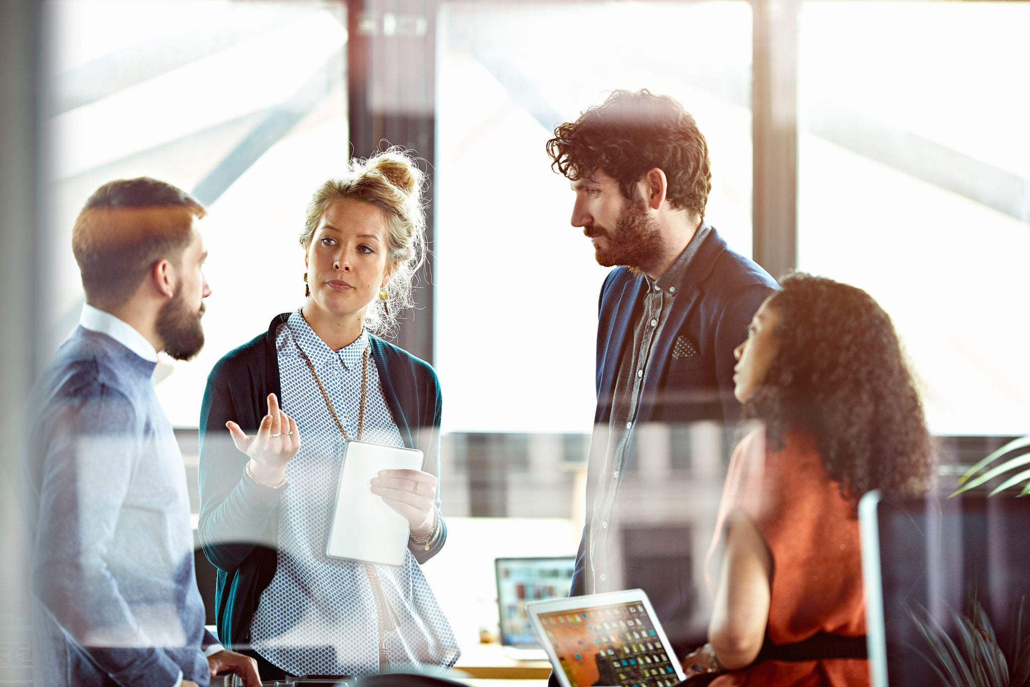 Men and women talking in modern office