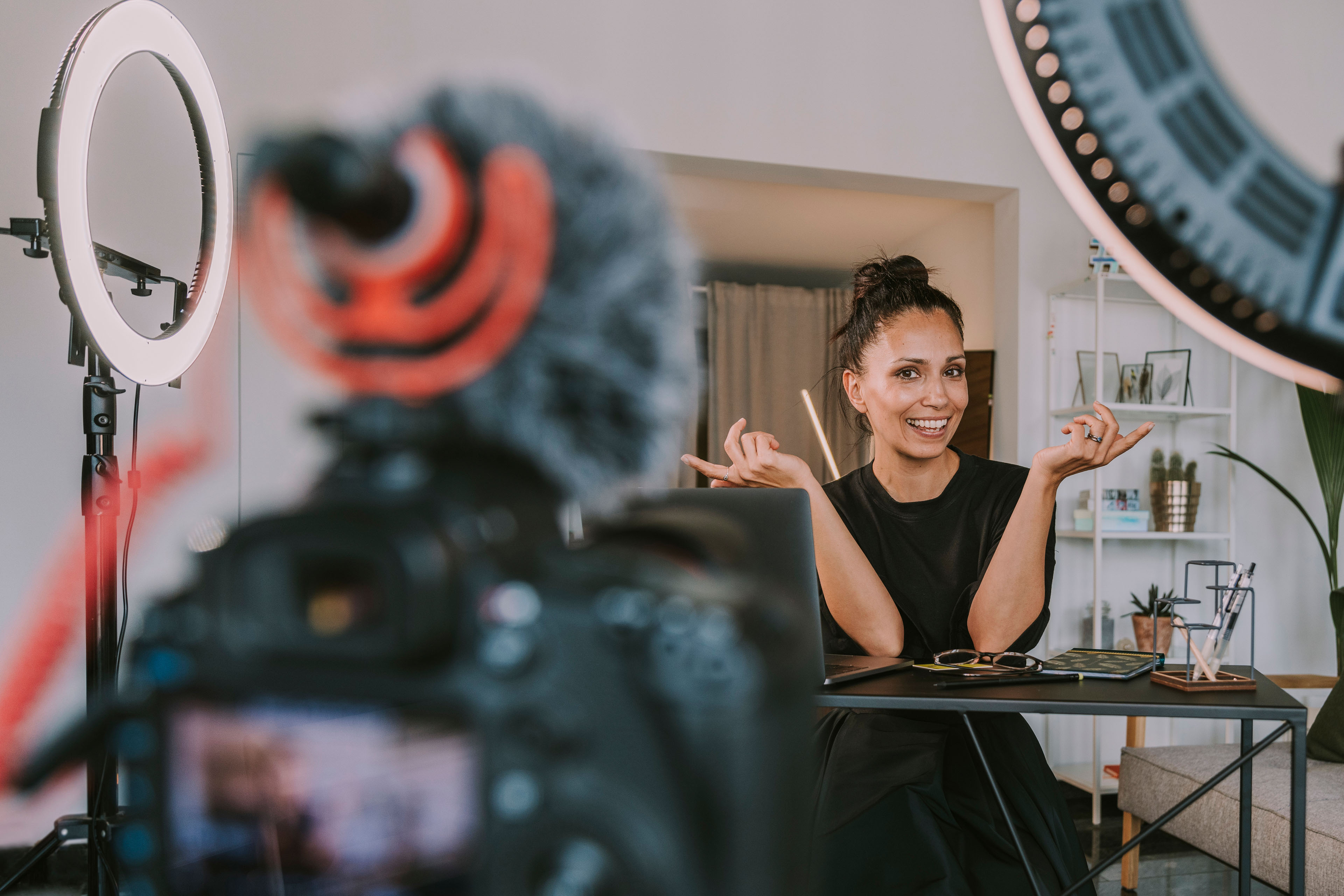 Female professional gesturing while vlogging at home