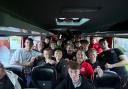 The team celebrating on the coach after the match