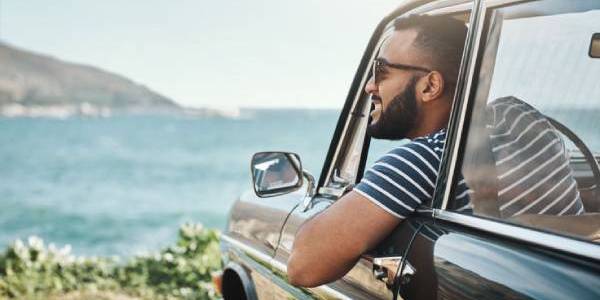 man looking out vehicle window