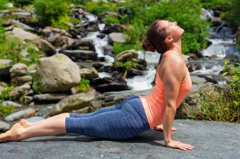 Woman doing the sun salutation sequence of poses.